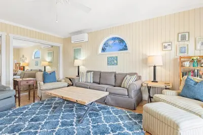 a living room with a couch and a table at High Cotton Beach Cottage in Inlet Beach
