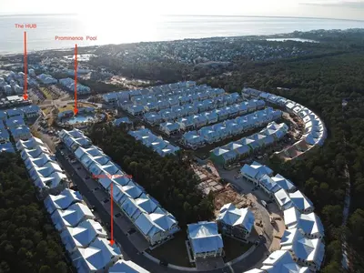 an aerial view of a complex with blue and white roofs at Settle By The Sea in Inlet Beach
