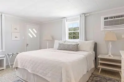 a white bedroom with a bed and a window at The Perfect View in Santa Rosa Beach