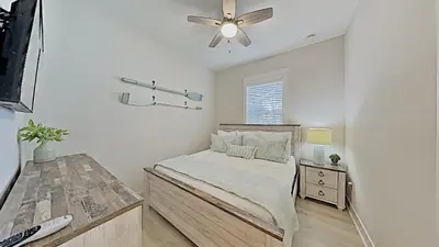 a bedroom with a bed and a ceiling fan at Prominence on 30A - Mint to Relax in Inlet Beach