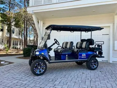 a blue golf cart parked in front of a house at Prominence on 30A - Mint to Relax in Inlet Beach