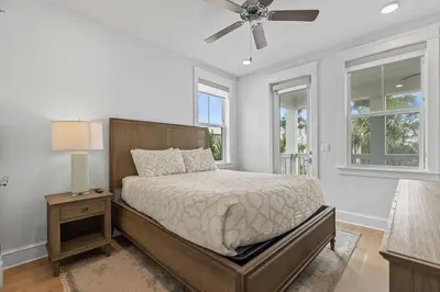 a bedroom with a bed and a ceiling fan at Crabbing Hole Lane in Rosemary Beach