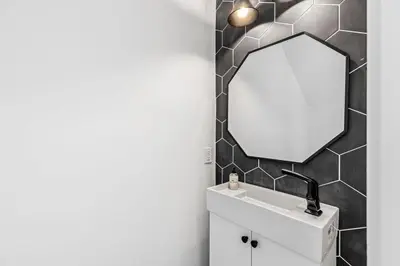a bathroom with a mirror and a sink at Shore To Please in Santa Rosa Beach