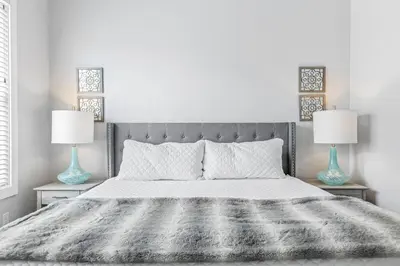 a bedroom with a large bed with two lamps at Shore To Please in Santa Rosa Beach