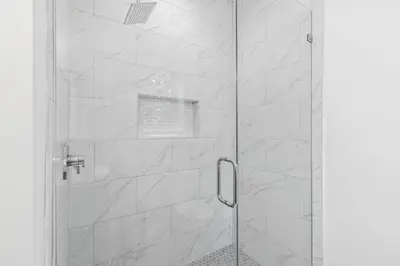 a shower with a glass door in a bathroom at Shore To Please in Santa Rosa Beach