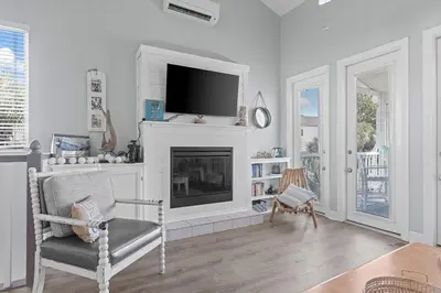 a living room with a fireplace and a tv at Time To Coast in Santa Rosa Beach