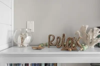 a white shelf with a wordoku on top of it at Time To Coast in Santa Rosa Beach