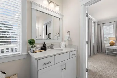 a white bathroom with a sink and a mirror at Casa Del Sol - Inlet Beach in Inlet Beach