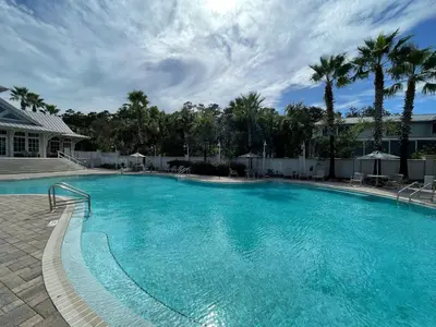 a large swimming pool with blue water at Casa Del Sol - Inlet Beach in Inlet Beach