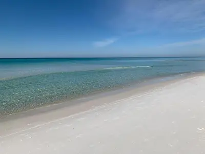 a beach with the ocean and the sky at The Little Pearl on 30A's Eastern Lake in Santa Rosa Beach