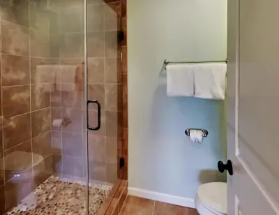 a bathroom with a shower and a toilet at Edgewater Villa 1908 in Panama City Beach