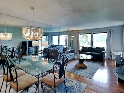 a living room with a glass table and a couch at Edgewater Villa 1913 in Panama City Beach