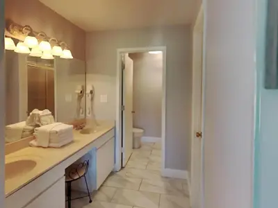 a bathroom with two sinks and a toilet at Edgewater Villa 1913 in Panama City Beach
