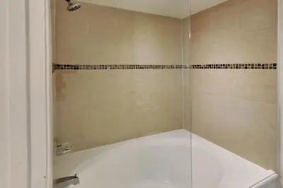 a bathroom with a shower with a glass door at Edgewater Villa #2104 in Panama City Beach