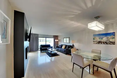 a living room with a glass table and a couch at Edgewater Villa #2104 in Panama City Beach