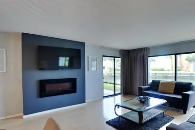 a living room with a couch and a fireplace at Edgewater Villa #2104 in Panama City Beach
