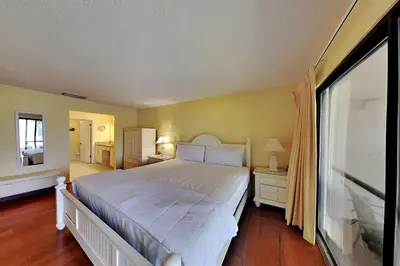 a bedroom with a large white bed and a window at Edgewater Villa 1916 in Panama City Beach