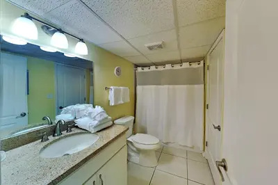 a bathroom with a sink and a toilet and a shower at Edgewater Villa 1916 in Panama City Beach