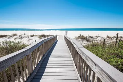a boardwalk to the beach on a sunny day at Edgewater Villa 1916 in Panama City Beach