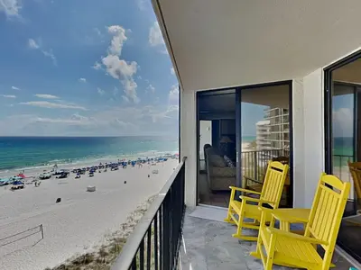 a balcony with yellow chairs and a view of the beach at Edgewater Tower III 513 in Panama City Beach