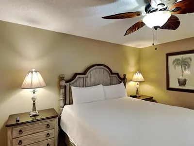 a bedroom with a bed and a ceiling fan at Edgewater Tower III 513 in Panama City Beach