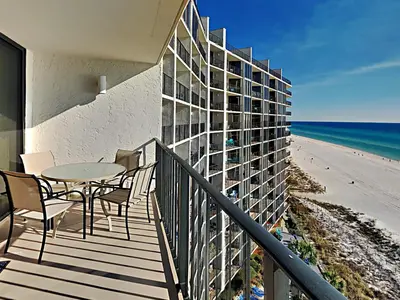a balcony with a table and chairs and the beach at Edgewater Tower III 911 in Panama City Beach