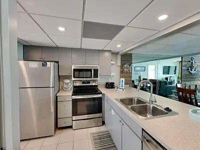 a kitchen with a stainless steel refrigerator and a sink at Edgewater Tower III 911 in Panama City Beach