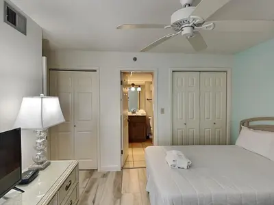 a bedroom with a bed and a ceiling fan at Edgewater Tower III #1002 in Panama City Beach