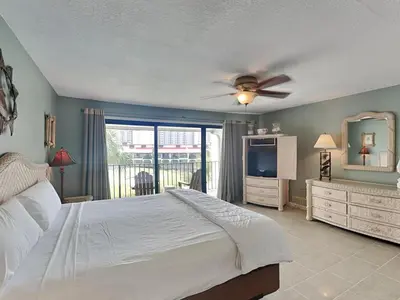 a bedroom with a bed and a ceiling fan at Edgewater Villa 124 in Panama City Beach