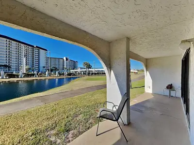 a chair sitting on a porch next to a body of water at Edgewater Villa #502 in Panama City Beach