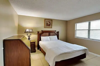 a bedroom with a large bed and a window at Edgewater Villa #502 in Panama City Beach