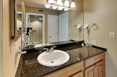 a bathroom with a sink and a mirror at Edgewater Villa #502 in Panama City Beach