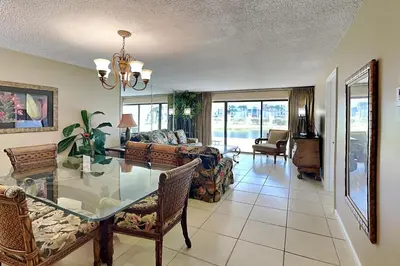 a living room with a glass table and a couch at Edgewater Villa #502 in Panama City Beach