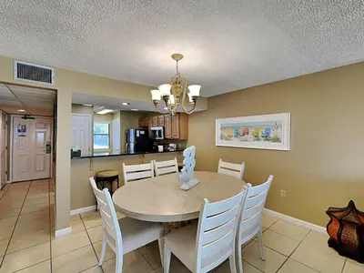 a dining room and kitchen with a table and chairs at Edgewater Villa #502 in Panama City Beach