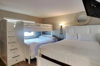 a bedroom with two beds and a bunk bed at Edgewater Villa #505 in Panama City Beach