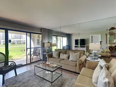a living room with a couch and a table at Edgewater Villa #505 in Panama City Beach