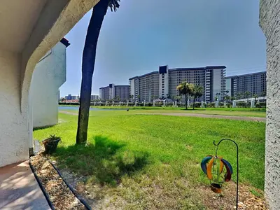 a palm tree and a golf ball in a field at Edgewater Villa #505 in Panama City Beach