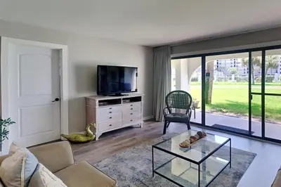 a living room with a couch and a tv at Edgewater Villa #505 in Panama City Beach