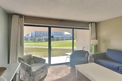 a living room with a couch and a chair at Edgewater Villa #506 in Panama City Beach
