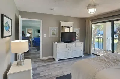 a bedroom with a bed and a television on a dresser at Edgewater Villa #512 in Panama City Beach
