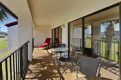 a balcony with chairs and a table on it at Edgewater Villa #512 in Panama City Beach