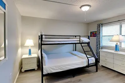a bedroom with two bunk beds and two lamps at Edgewater Villa #602 in Panama City Beach