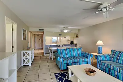 a living room with two blue couches and a table at Edgewater Villa #602 in Panama City Beach