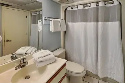 a bathroom with a sink and a toilet and a shower at Edgewater Villa #602 in Panama City Beach