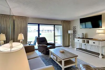 a living room with a couch and a table at Edgewater Villa #604 in Panama City Beach