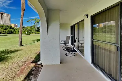 a porch of a house with chairs on it at Edgewater Villa #604 in Panama City Beach