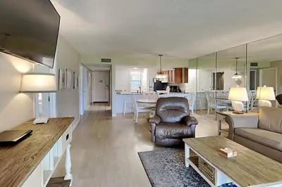 a living room with a couch and a table at Edgewater Villa #604 in Panama City Beach