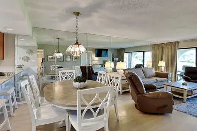 a kitchen and living room with a table and chairs at Edgewater Villa #604 in Panama City Beach