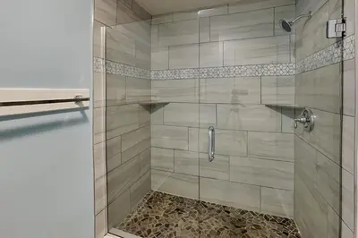 a shower with a glass door in a bathroom at Edgewater Villa #712 in Panama City Beach