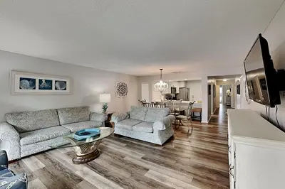 a living room with a couch and a table at Edgewater Villa #712 in Panama City Beach
